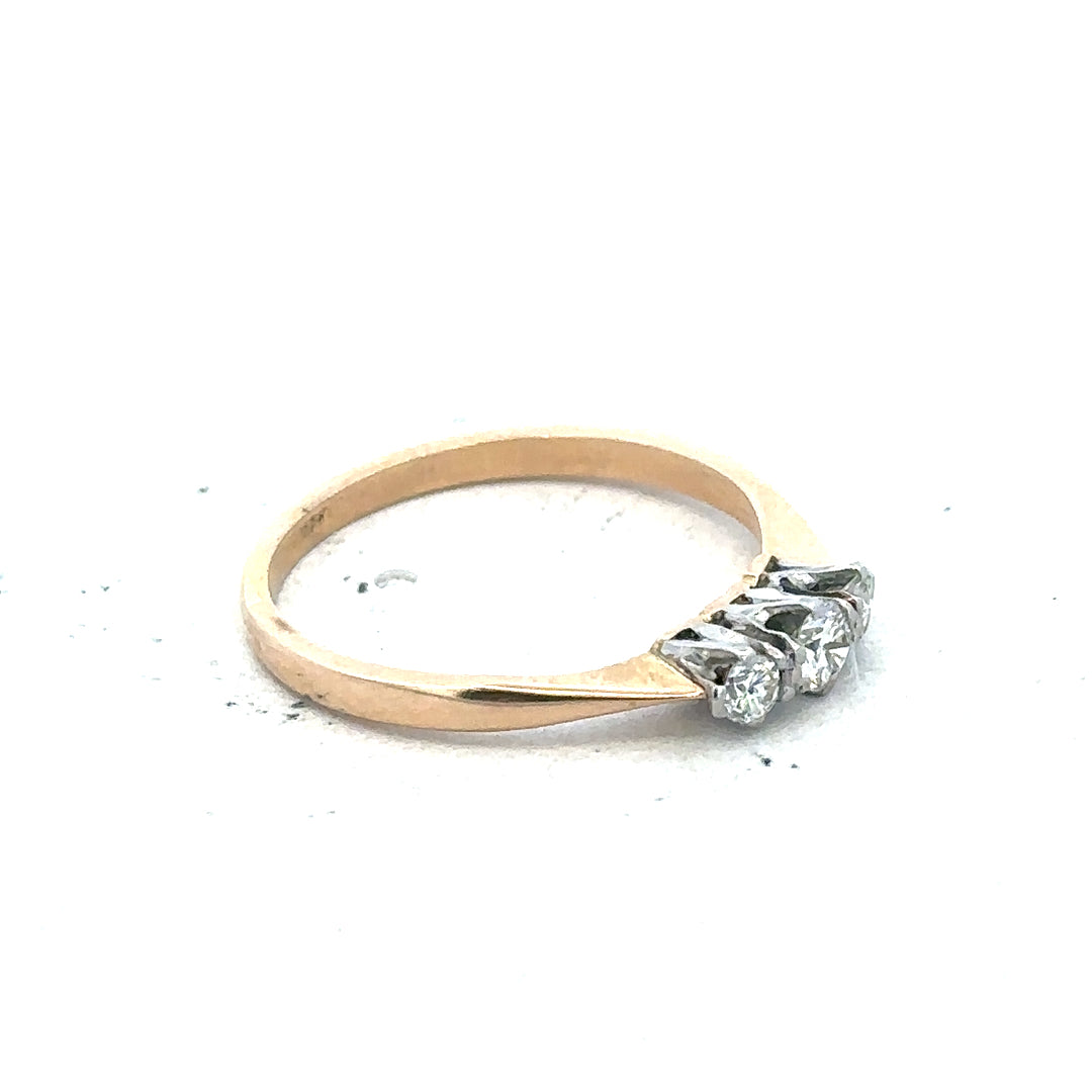 18ct yellow gold three diamond ring with a sleek band and sparkling diamonds, showcasing elegant jewelry craftsmanship.