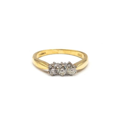 18ct yellow gold three diamond ring with a sleek band and sparkling stones, showcasing elegant jewelry craftsmanship.