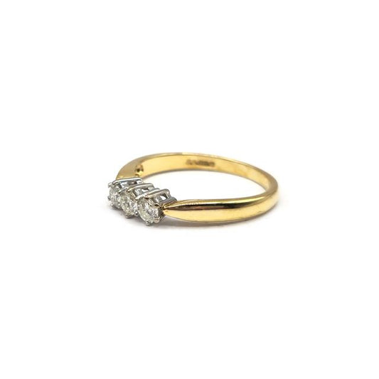 18ct yellow gold three-diamond ring featuring a sleek band and sparkling stones, showcasing elegant jewelry design.
