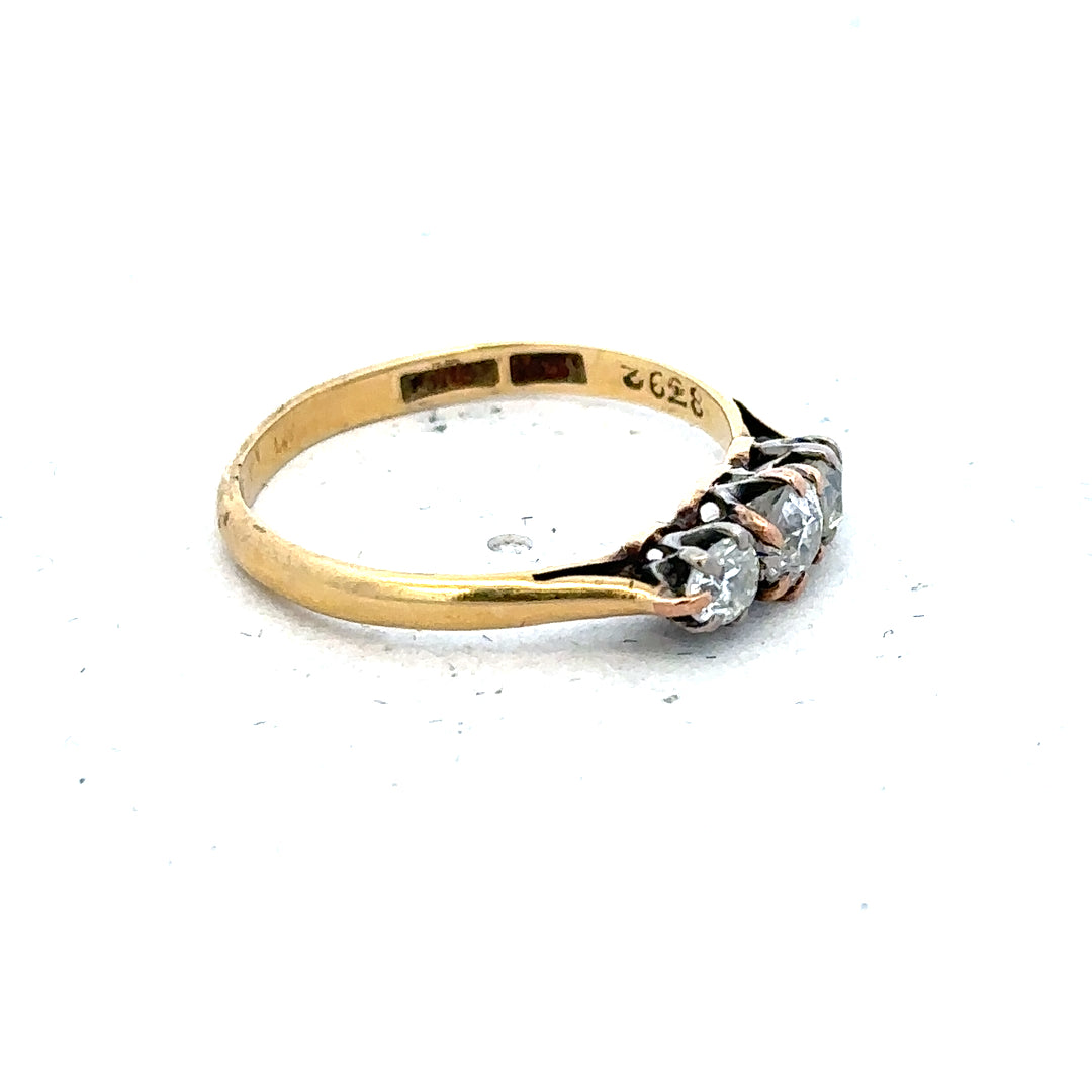 18ct yellow gold three diamond ring in size L, featuring a sleek band and sparkling diamonds on a plain background.