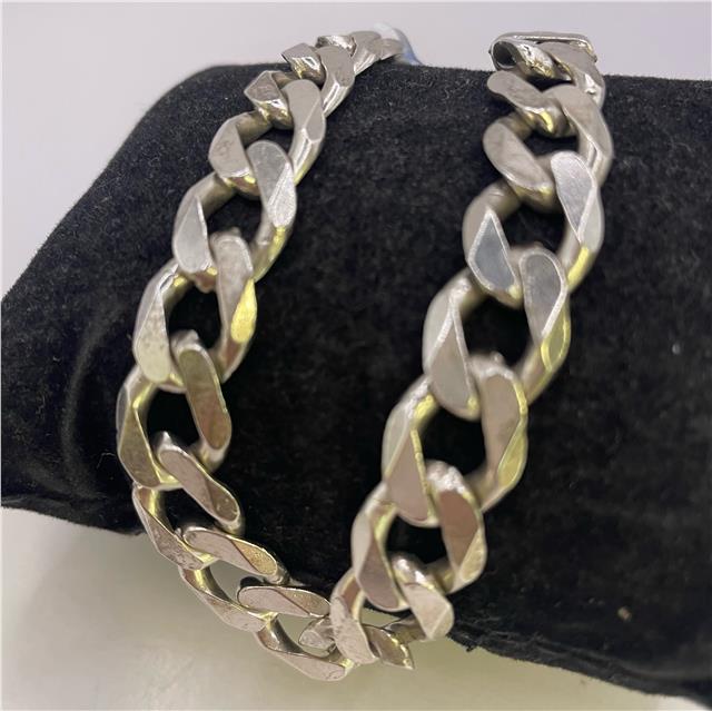 Silver bracelet made of 925 sterling silver with intricate design, unbranded, shown on a plain background.