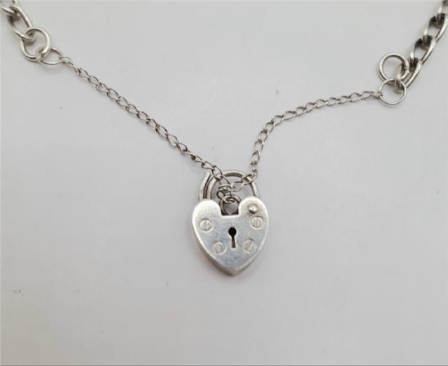 925 silver charm bracelet with detailed charms, unbranded, weighs 27.3 grams, featuring intricate silver jewelry design.