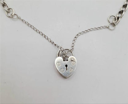 925 silver charm bracelet with detailed charms, unbranded, weighs 27.3 grams, featuring intricate silver jewelry design.