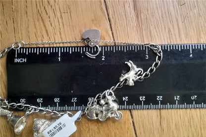 925 silver charm bracelet weighing 27.3g with various charms, unbranded, displayed on a neutral background.