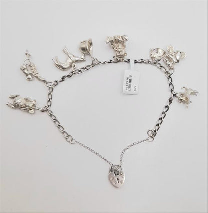 925 silver charm bracelet with intricate designs, weighing 27.3g, featuring a classic unbranded style in the image.