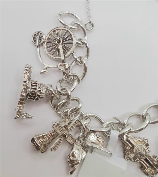 925 silver charm bracelet weighing 53.6g, 7-inch length, unbranded, showcasing detailed silver charms and craftsmanship.