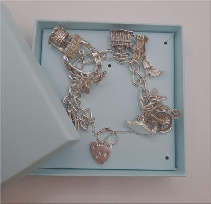 925 silver charm bracelet, 7-inch unbranded jewelry piece with intricate charms and 53.6g weight displayed on a neutral background.