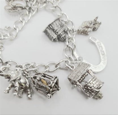 925 silver charm bracelet weighing 53.6g, 7 inches long, featuring various charms, unbranded jewelry accessory.