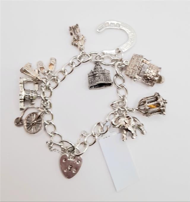 925 silver charm bracelet, 7-inch length, unbranded, with decorative charms and 53.6g weight, displayed in the image.