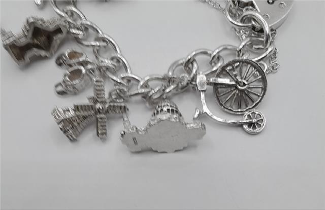925 silver charm bracelet weighing 53.6g, 7-inch length, unbranded jewelry with detailed charm accents and a secure clasp.