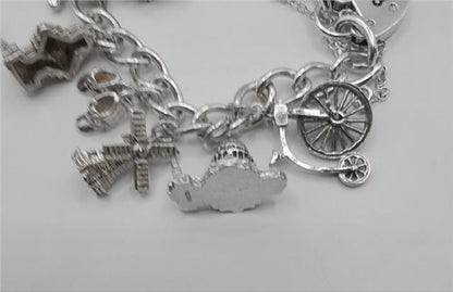 925 silver charm bracelet weighing 53.6g, 7-inch length, unbranded jewelry with detailed charm accents and a secure clasp.