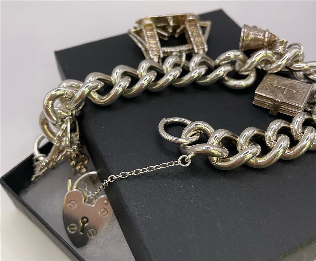 925 silver charm bracelet with intricate charms and adjustable chain, designed for a stylish and elegant look.