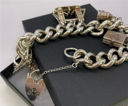 925 silver charm bracelet with intricate charms and adjustable chain, designed for a stylish and elegant look.