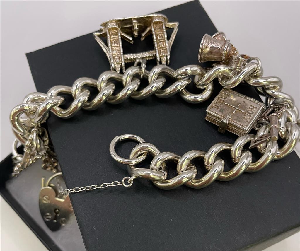 925 silver charm bracelet with decorative charms, unbranded jewelry accessory showcasing intricate details and polished finish.
