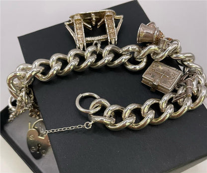 925 silver charm bracelet with decorative charms, unbranded jewelry accessory showcasing intricate details and polished finish.