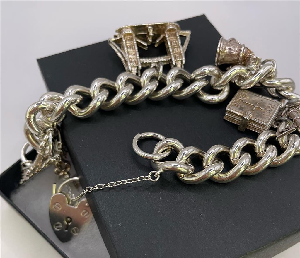 925 silver charm bracelet with intricate designs, featuring various charms and a secure clasp, perfect for adding a stylish touch.