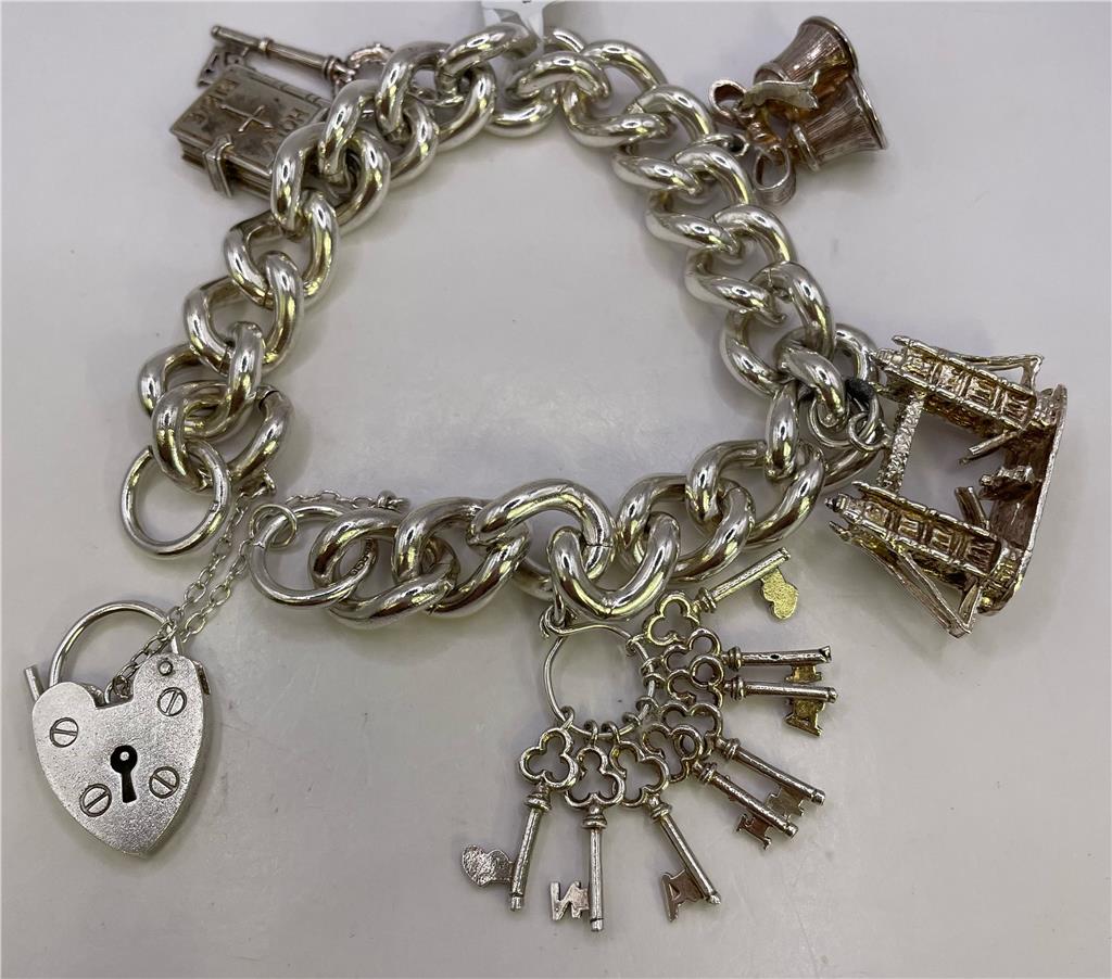 925 silver charm bracelet with intricate details, featuring various charms and a secure clasp, perfect for everyday wear.