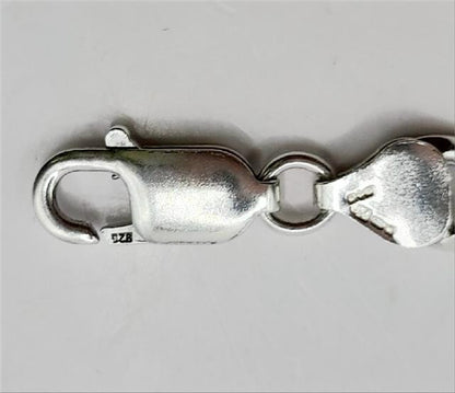 925 silver Figaro chain, 18-inch length, 37.7g, unbranded, detailed close-up showing polished links and craftsmanship.