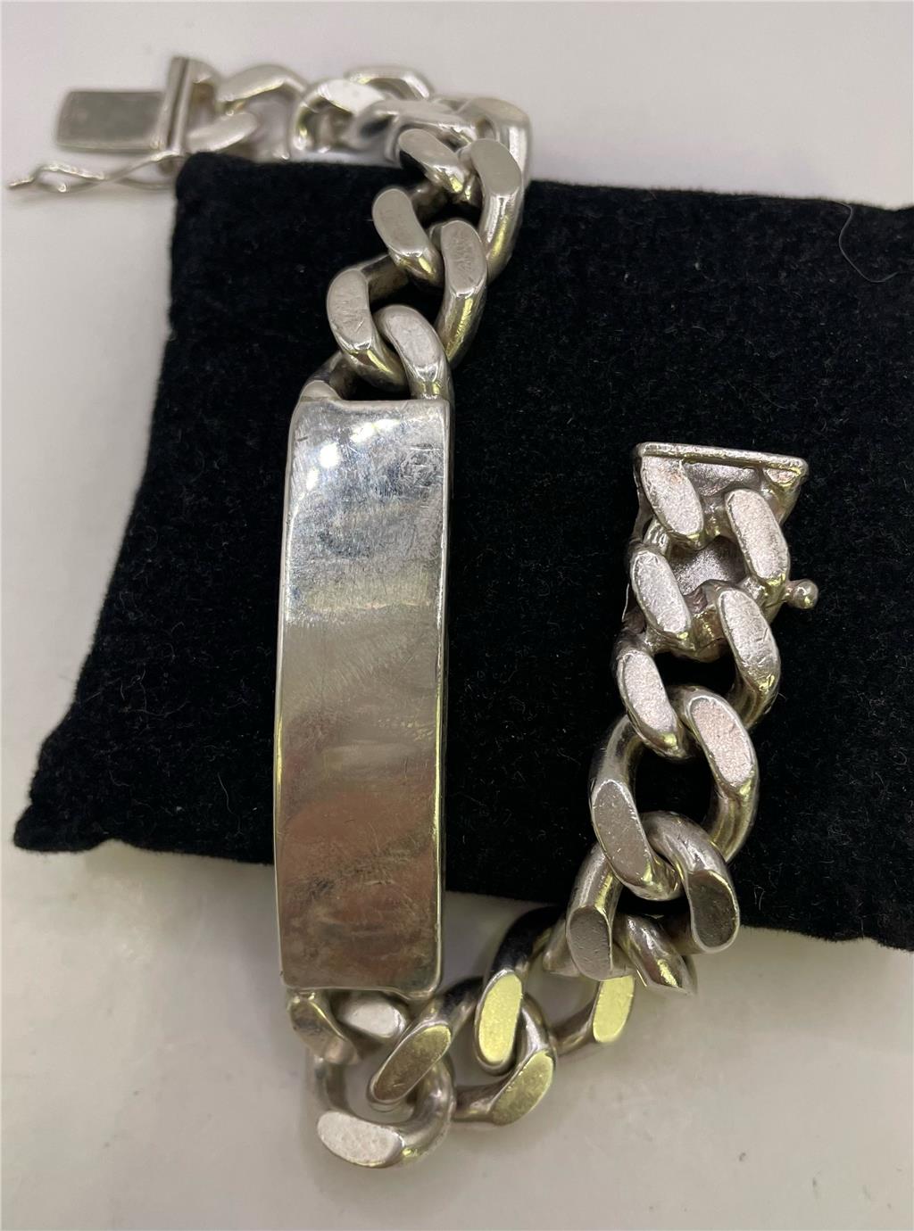 925 silver ID bracelet with engraved plate, unbranded, featuring a sleek chain design and secure clasp.