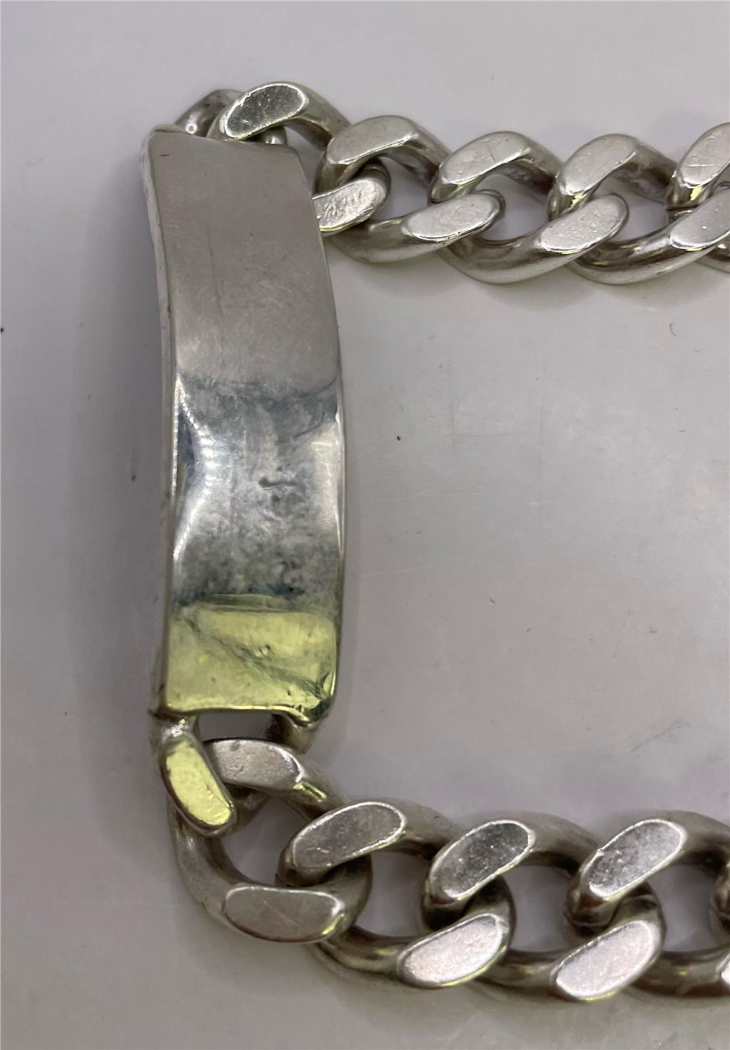 925 silver ID bracelet with engraved plate, unbranded jewelry, showcasing a sleek, polished silver design on a white background.