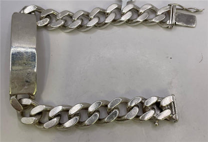 Sterling silver ID bracelet with engraved plate, unbranded, showcasing a sleek and polished design on a plain background.