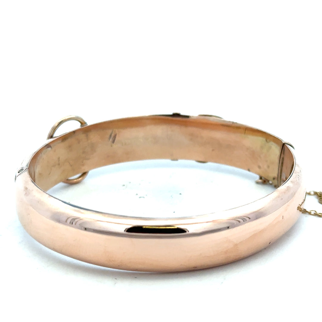 9ct gold bangle weighing 17.9g, featuring a smooth, polished finish, perfect for elegant jewelry styling.
