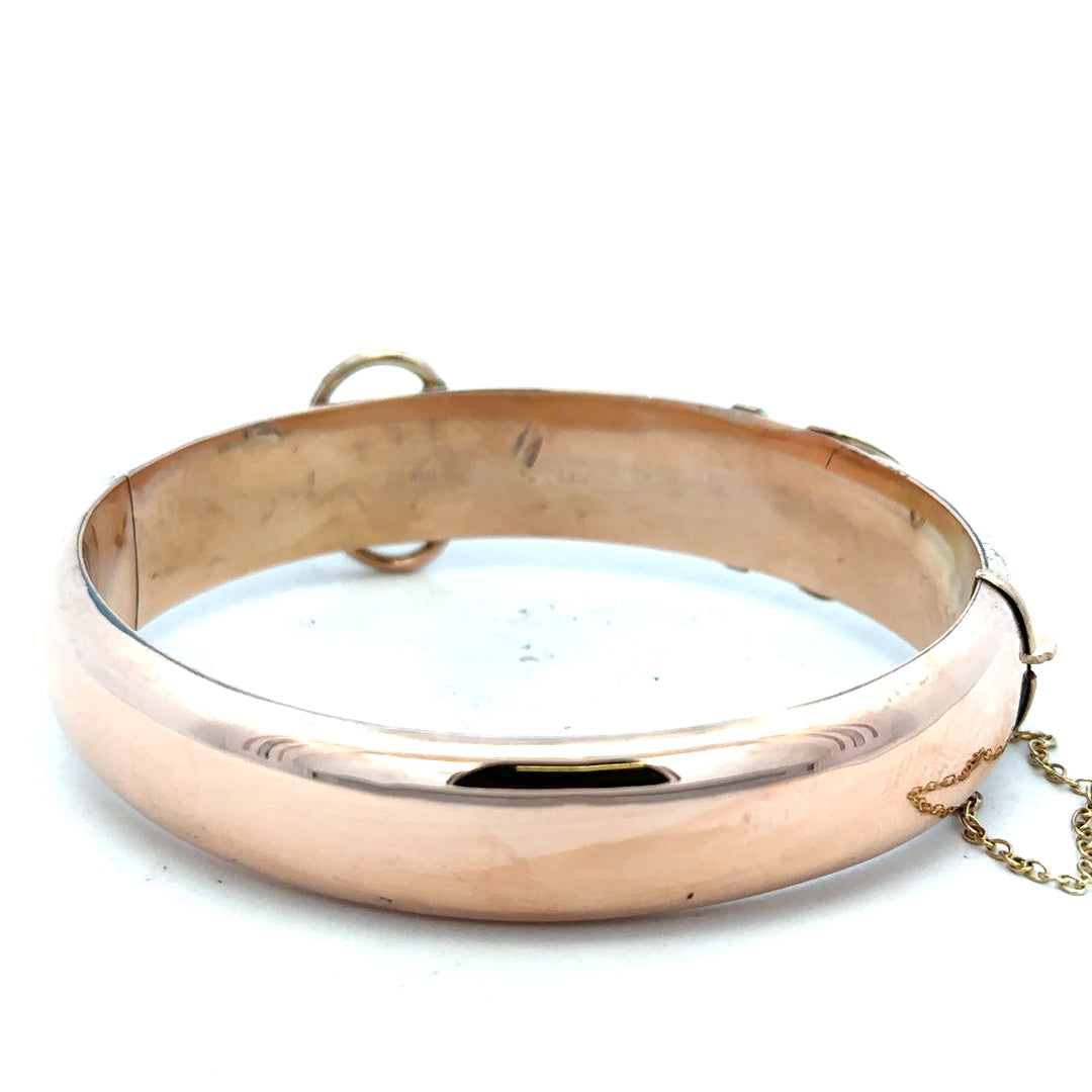 9ct gold bangle weighing 17.9g, unbranded, with a smooth polished finish and rounded design.