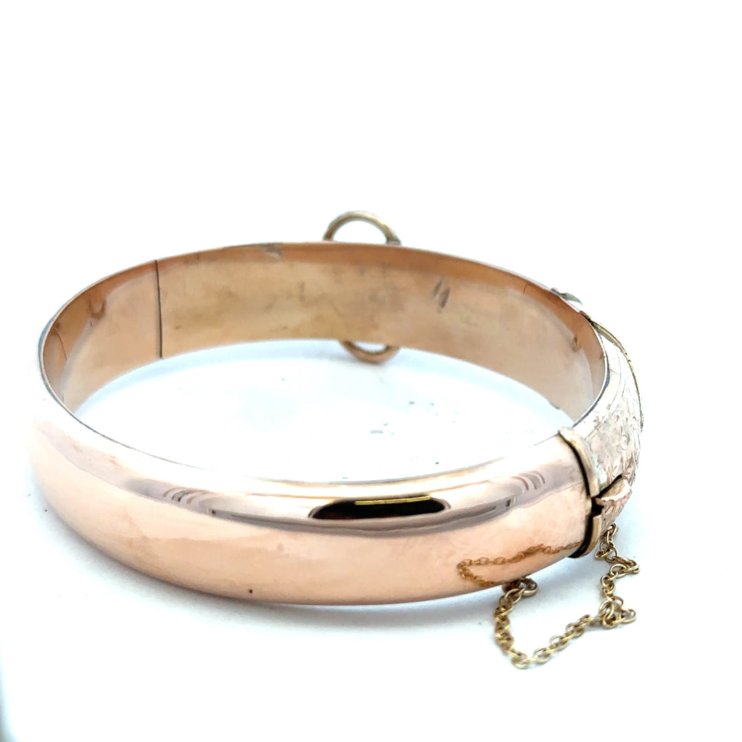 9ct gold bangle weighing 17.9g with a smooth, polished finish, designed for elegant wristwear.