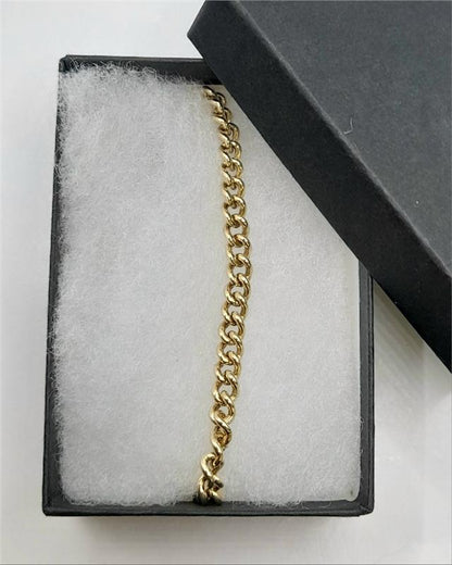 9ct gold bracelet with a 12.6g weight and 21cm length, featuring a sleek unbranded design.