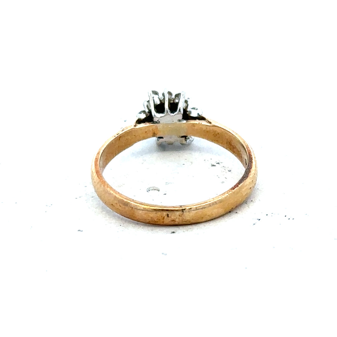 9ct gold diamond ring with a sparkling central diamond and delicate band, unbranded jewelry piece.
