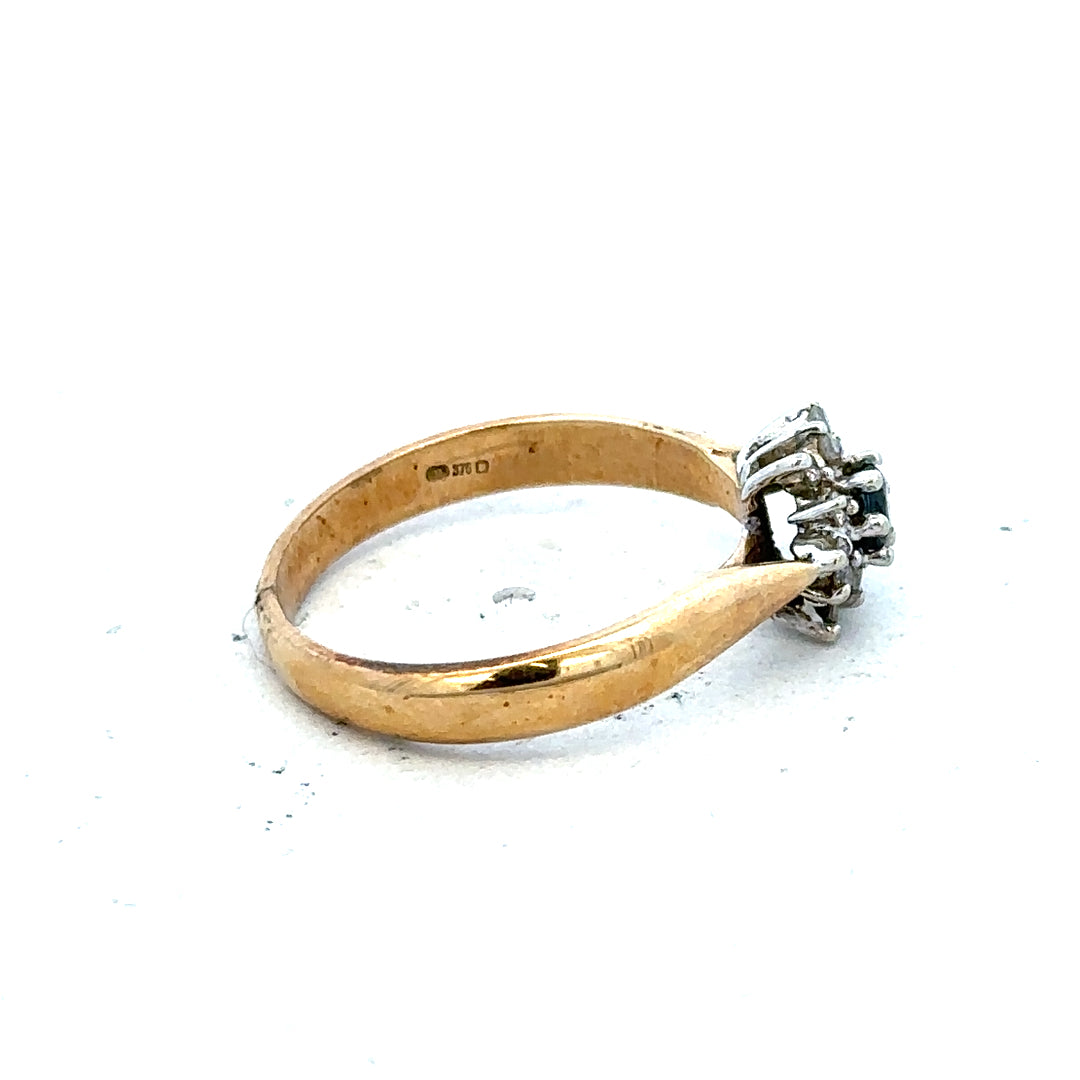 9ct gold diamond ring with a sparkling central diamond and intricate band design, showcasing elegant jewelry craftsmanship.