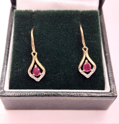 9ct gold ruby earrings featuring vibrant red rubies set in gold, elegant jewelry with a classic design.