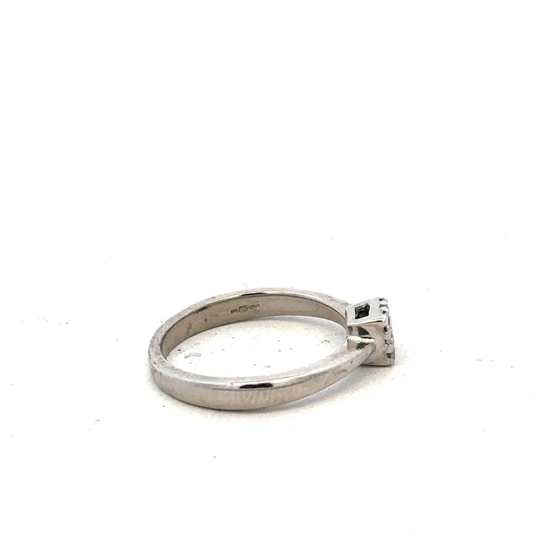9ct white gold diamond ring with 15pts of diamonds in size K1/2, featuring a sleek design and sparkling stone details.