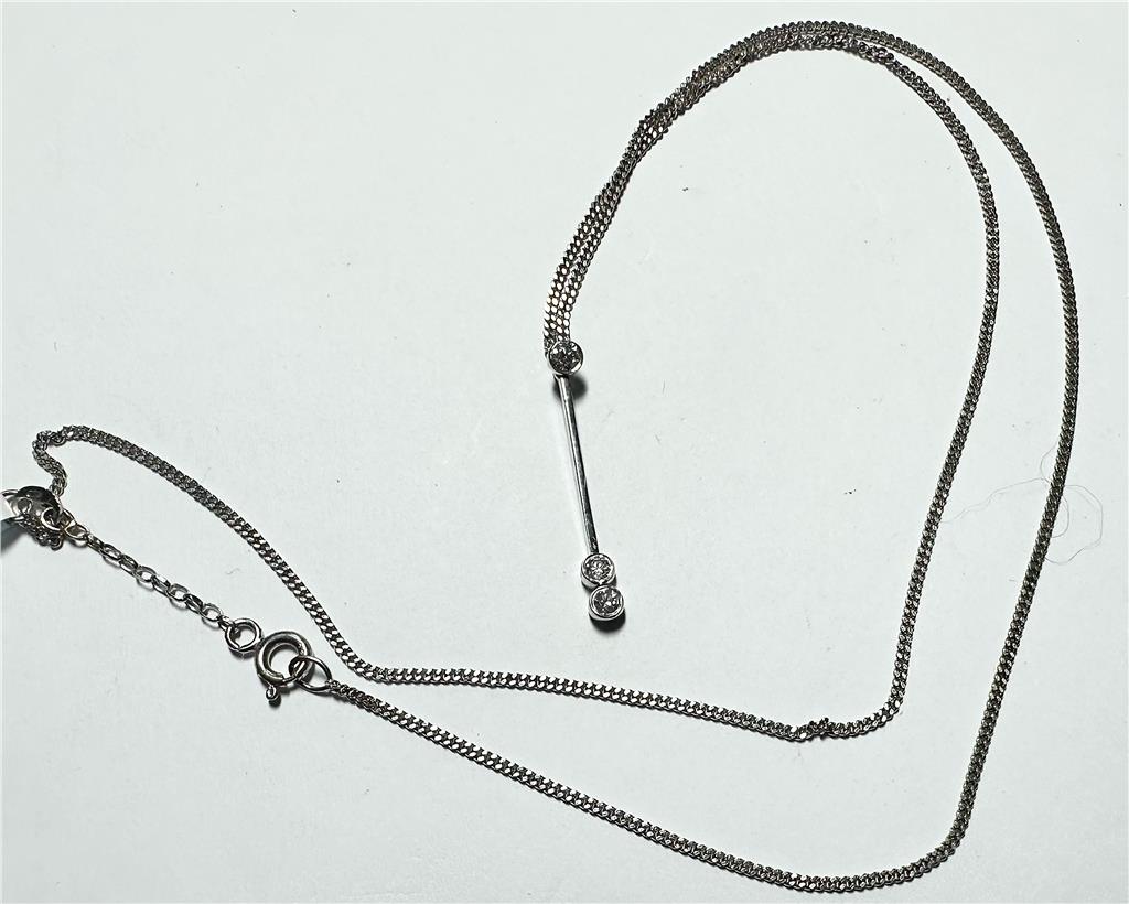 9ct white gold chain with 18ct white gold diamond pendant, featuring sparkling diamonds and a delicate design.