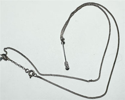 9ct white gold chain with 18ct white gold diamond pendant, featuring sparkling diamonds and a delicate design.