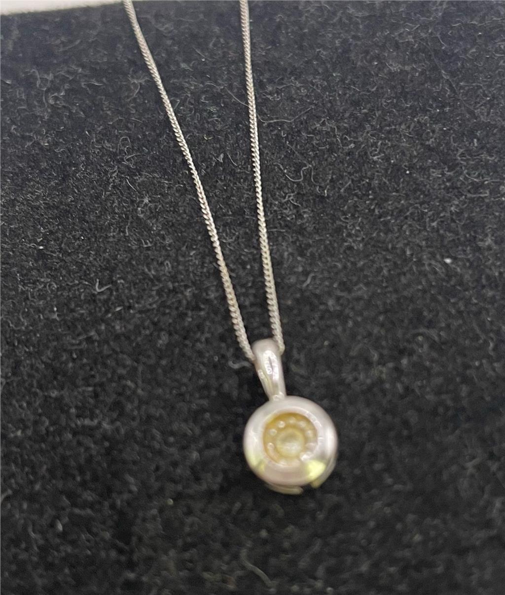 9ct white gold chain and pendant featuring a sleek design, perfect for elegant jewelry wear.