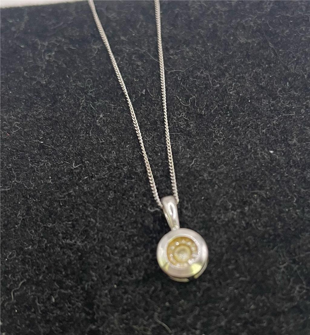 9ct white gold chain with pendant, showcasing a sleek and elegant jewelry piece with detailed craftsmanship.