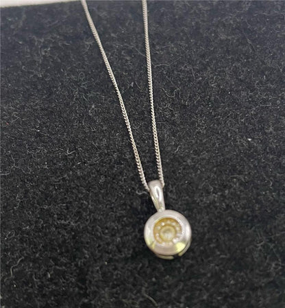 9ct white gold chain with pendant, showcasing a sleek and elegant jewelry piece with detailed craftsmanship.