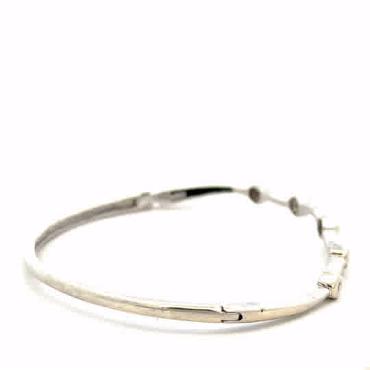 9ct white gold diamond bangle with sparkling diamonds, showcasing elegant jewelry design and craftsmanship.