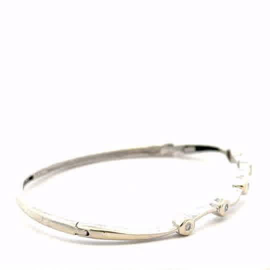 9ct white gold diamond bangle with sparkling diamonds, showcasing elegant design and craftsmanship, weight 7.7g.