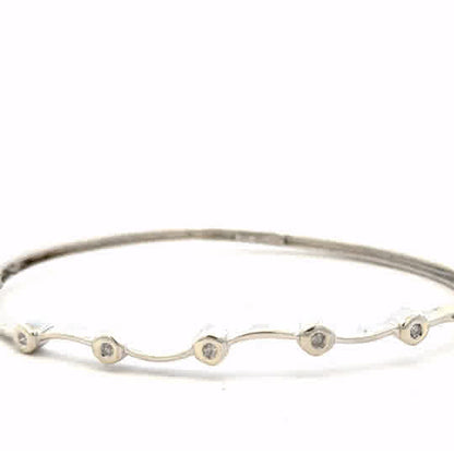 9ct white gold diamond bangle with sparkling diamonds, weighs 7.7g, elegant jewelry piece showcasing fine craftsmanship.