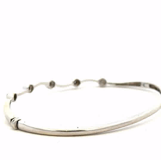 9ct white gold diamond bangle with sparkling diamonds, lightweight and elegant jewelry piece, unbranded.