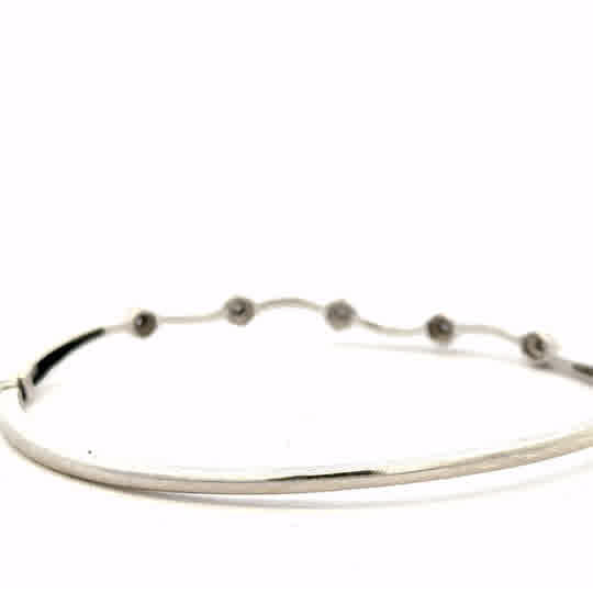 9ct white gold diamond bangle with sparkling diamonds, weight 7.7g, featuring a sleek and elegant design.