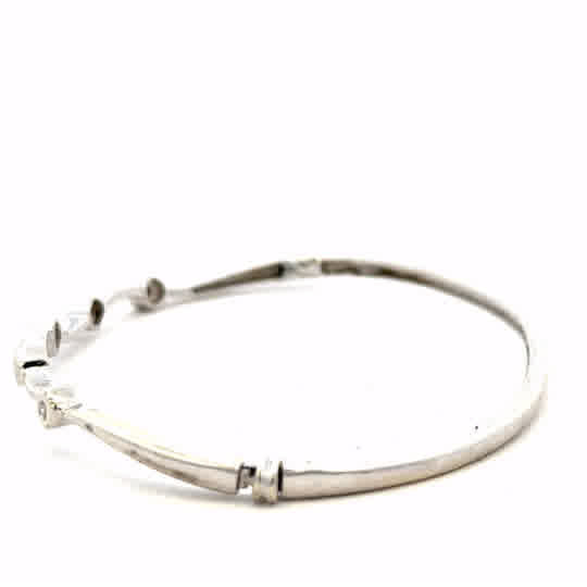 9ct white gold diamond bangle with sparkling diamonds, weighing 7.7g, elegant jewelry piece featuring a sleek design