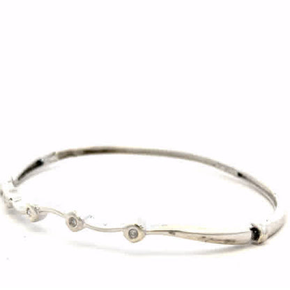 9ct white gold diamond bangle with sparkling diamonds, weighing 7.7g, featuring an elegant and timeless design.