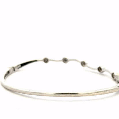 9ct white gold diamond bangle with sparkling diamonds, weighing 7.7g, elegant jewelry piece featuring a sleek design.