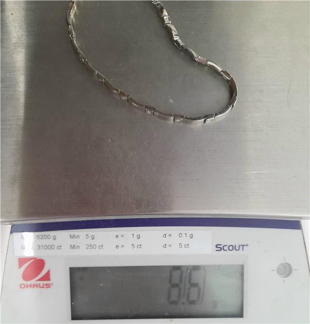 9ct white gold diamond bracelet with delicate design, 8 inches long, weighing 8.6 grams, showcasing sparkling diamonds.