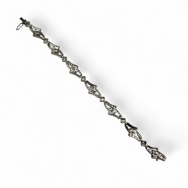 9ct white gold diamond bracelet with sparkling stones, featuring a delicate design and secure clasp on a neutral background.