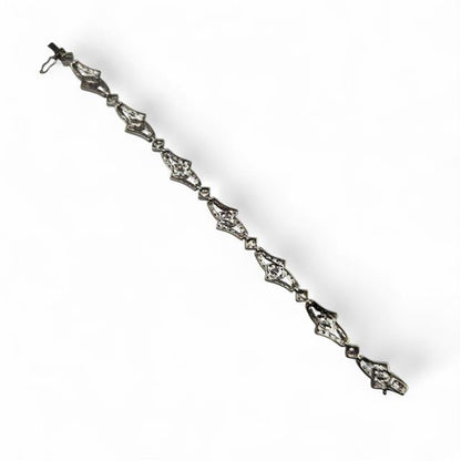 9ct white gold diamond bracelet with sparkling stones, featuring a delicate design and secure clasp on a neutral background.