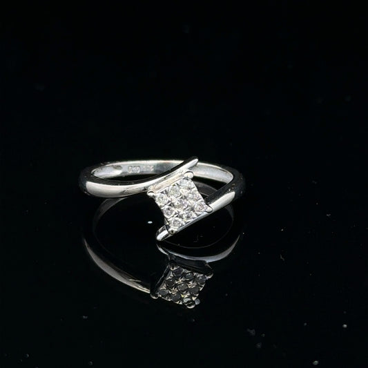 9ct white gold diamond cluster ring with a 10-point sparkling diamond centerpiece, showcasing elegant craftsmanship.